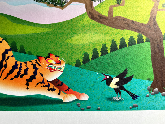 12x18 Color 2022 Calendar Year of the Tiger Print for home, apartment, and room decor. Printed in full color with all 12 months of the year. Inspired by Korean minhwa painting, a magpie scares the wits out of a tiger in a lush landscape of lotus, pine, and rolling hills. Close-up photo for detail.